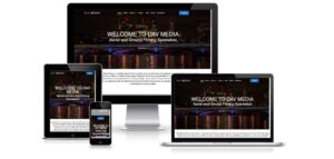 A desktop computer, laptop, tablet, and smartphone displaying the homepage of a website for 'Day Media,' an aerial and ground filming company. The site showcases a city skyline at night with illuminated buildings. Consistent web design in Horsham ensures the same image and text on all devices.